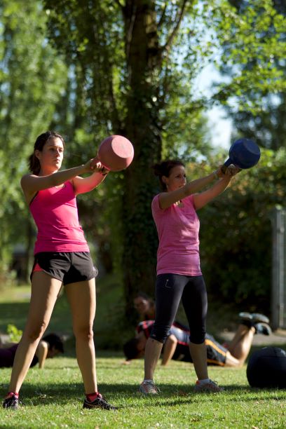 Couple kettlebell swing outdoor